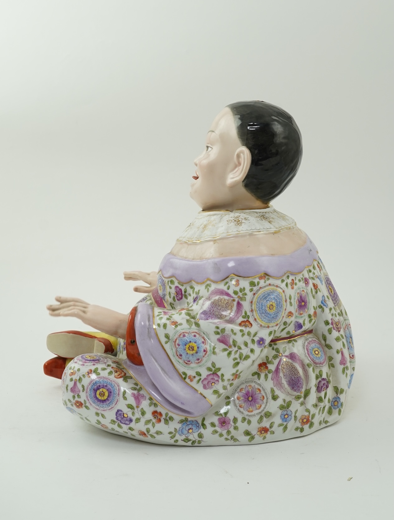A large Continental porcelain figure of a seated nodding Buddha, early 20th century
